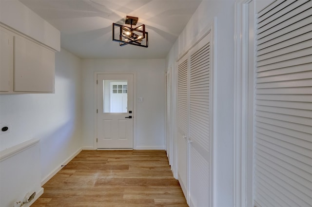 entryway featuring a chandelier and light wood-type flooring