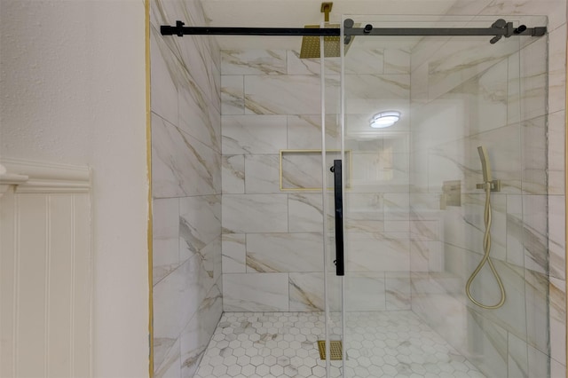 bathroom featuring a shower with shower door