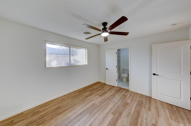 unfurnished bedroom with ensuite bath, ceiling fan, and light wood-type flooring