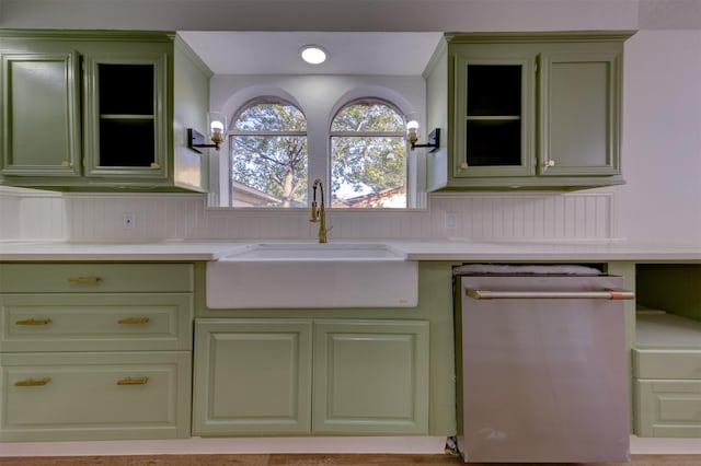 kitchen featuring green cabinets, dishwasher, and sink