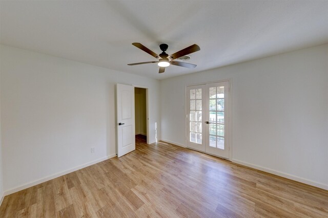 spare room with ceiling fan, light wood-type flooring, and french doors