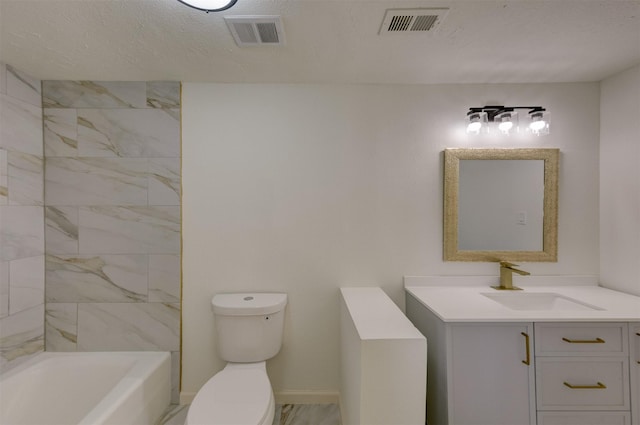 bathroom with vanity, a textured ceiling, and toilet