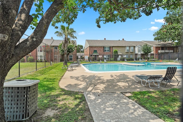 view of pool featuring a patio and a lawn