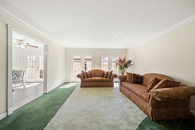 living room with carpet, french doors, crown molding, ceiling fan, and a textured ceiling