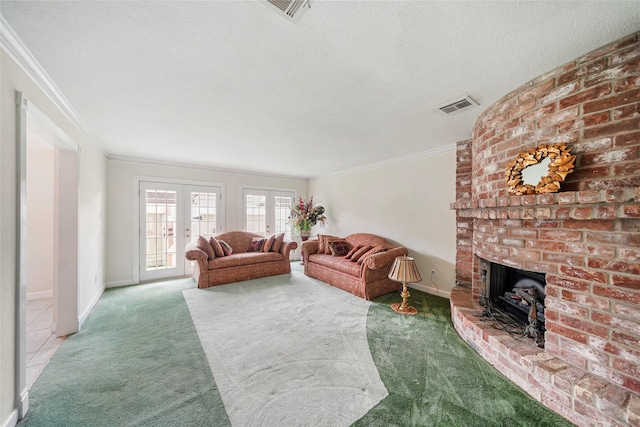 carpeted living room with french doors, a textured ceiling, a brick fireplace, and crown molding