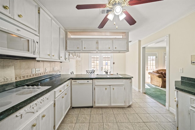 kitchen with kitchen peninsula, white cabinetry, white appliances, and sink