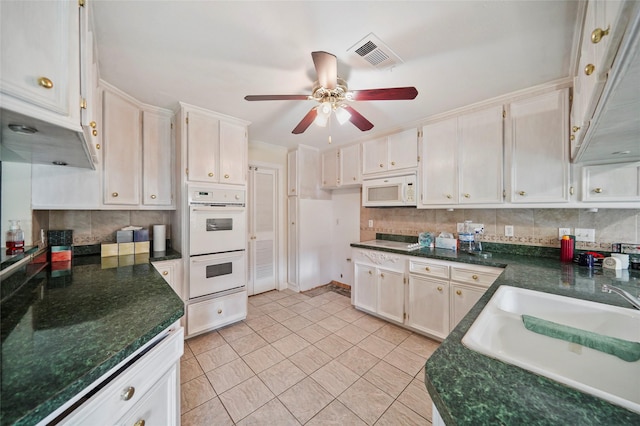 kitchen with decorative backsplash, white appliances, white cabinetry, and sink