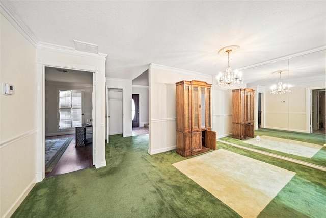 interior space with dark colored carpet, ornamental molding, and a notable chandelier