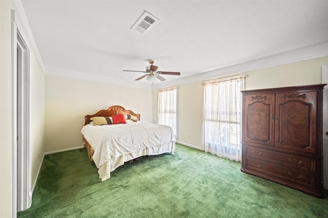 carpeted bedroom with ceiling fan and crown molding