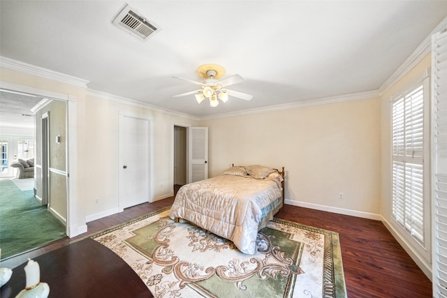 bedroom with multiple windows, ornamental molding, ceiling fan, and dark wood-type flooring