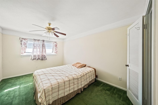 bedroom with ceiling fan, dark carpet, and ornamental molding