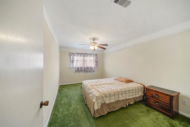 carpeted bedroom featuring ceiling fan and ornamental molding