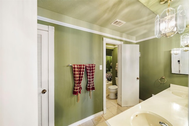 bathroom featuring toilet, vanity, and tile patterned floors