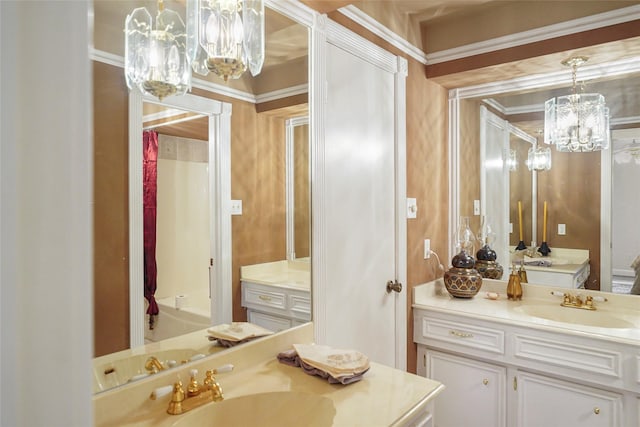 bathroom featuring vanity, crown molding, and a notable chandelier