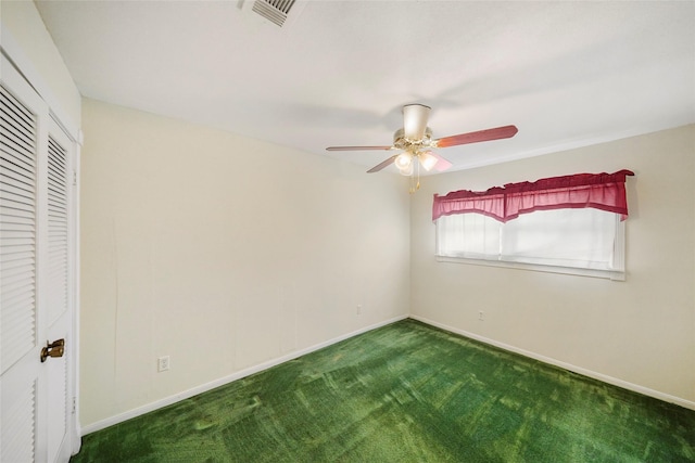 unfurnished bedroom with dark carpet and ceiling fan