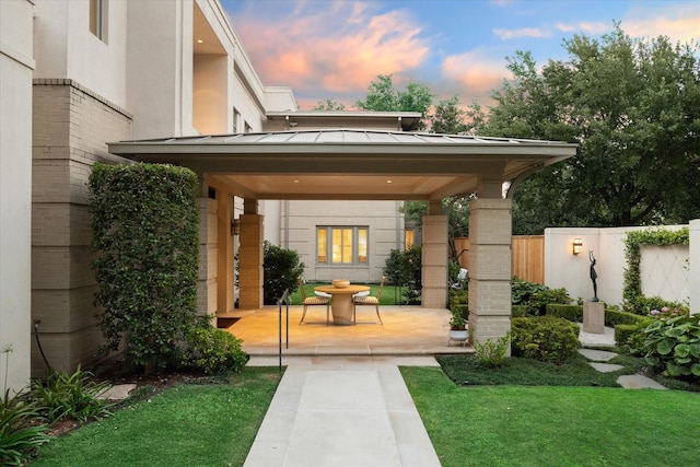 exterior space featuring a patio area and a lawn