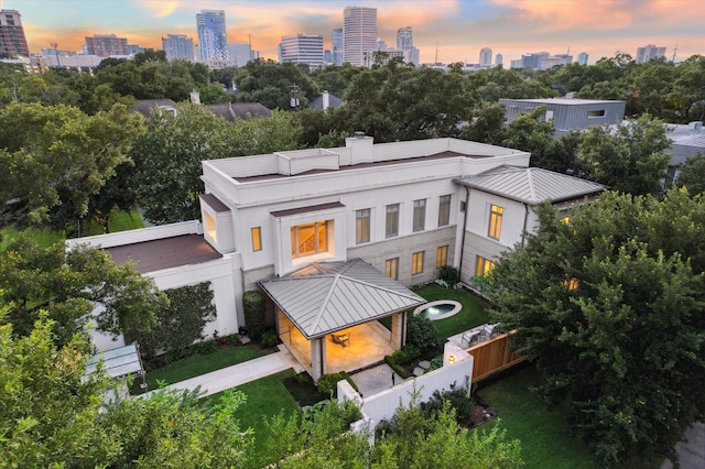 view of back house at dusk