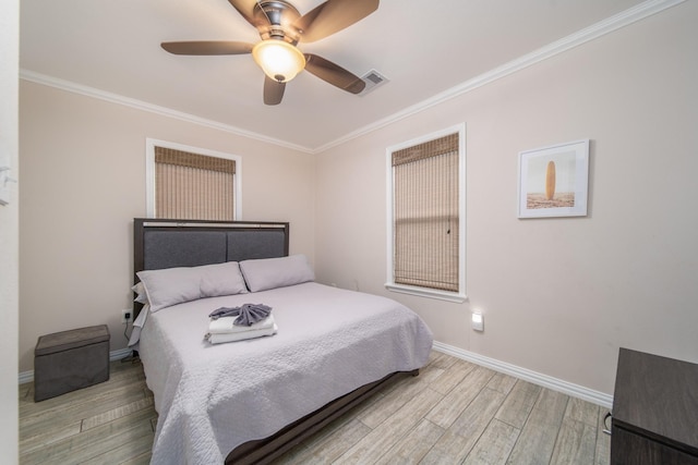 bedroom with light wood-type flooring, ceiling fan, and crown molding