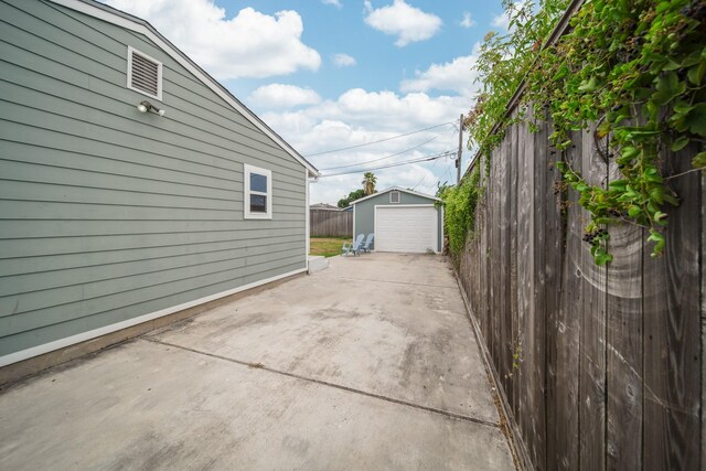 view of patio / terrace featuring an outbuilding and a garage