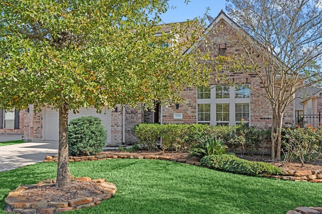 obstructed view of property with a front lawn