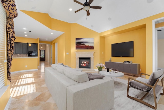 living room featuring ceiling fan and lofted ceiling