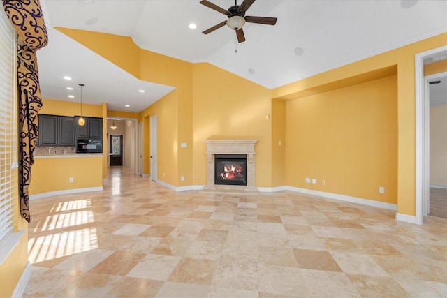 unfurnished living room featuring ceiling fan and ornamental molding