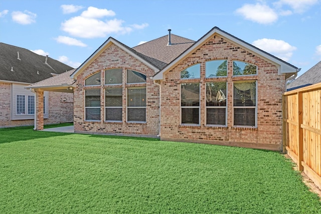 back of property featuring a lawn