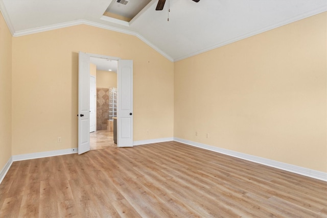 spare room featuring light hardwood / wood-style floors, vaulted ceiling, ceiling fan, and crown molding