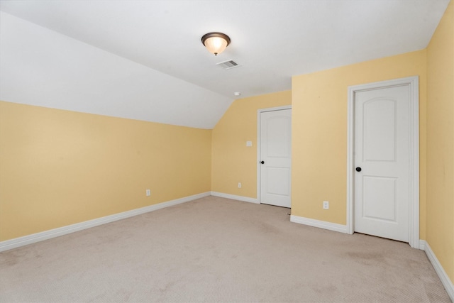 bonus room with light carpet and lofted ceiling