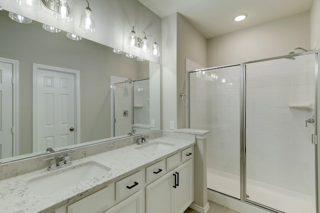 bathroom featuring vanity and a shower with shower door