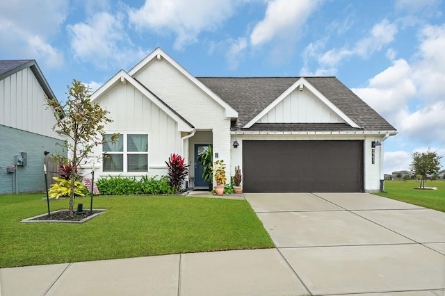 view of front of house featuring a front yard and a garage