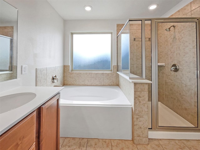 bathroom featuring tile patterned floors, vanity, and independent shower and bath