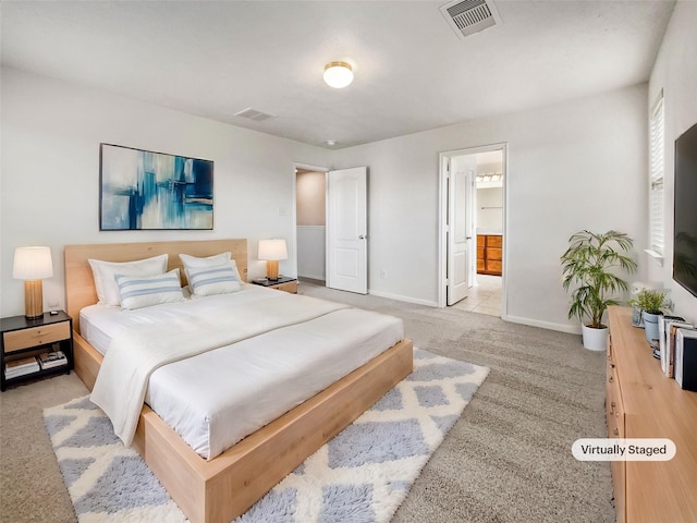 carpeted bedroom featuring connected bathroom