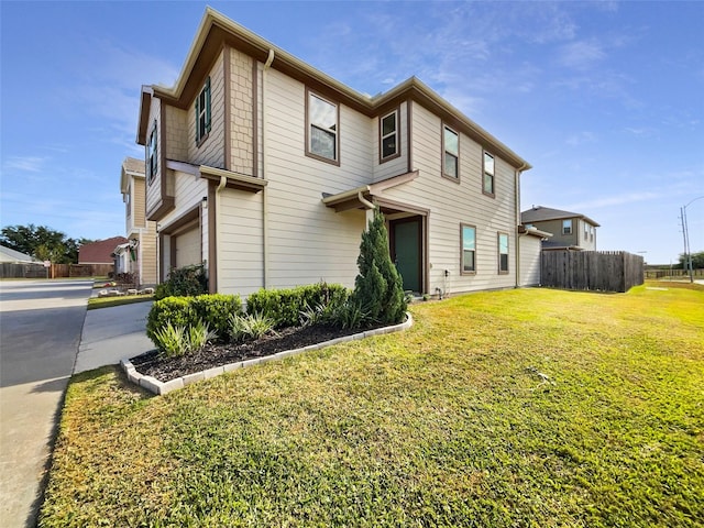 view of front of home featuring a garage and a front lawn