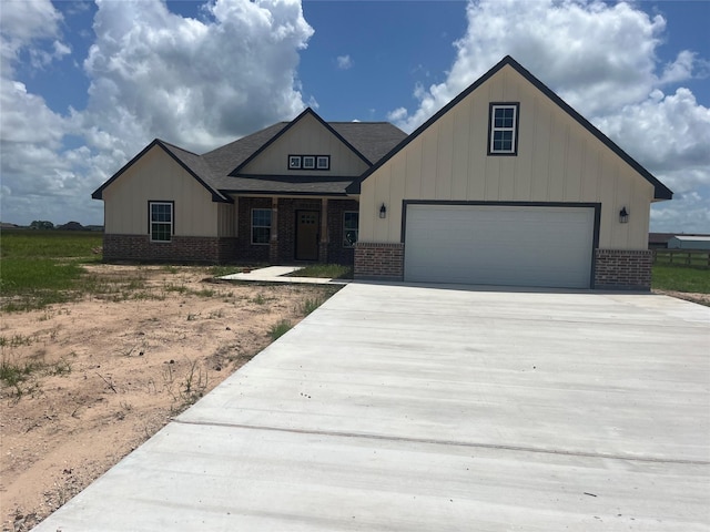 643 Longhorn Trl, Angleton, TX 77515 - view of front of home featuring brick siding, concrete driveway, board and batten siding, and roof with shingles