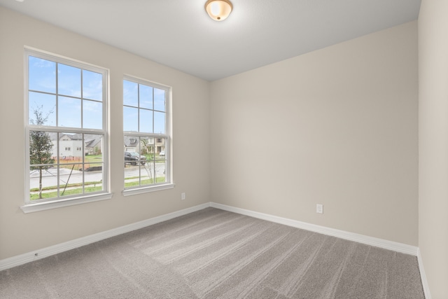 carpeted spare room featuring plenty of natural light