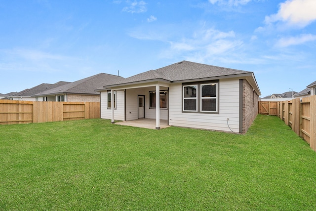 back of property featuring a yard and a patio