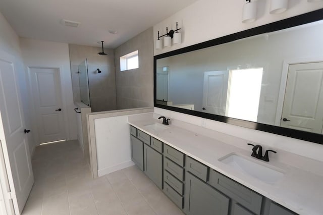 full bathroom with tile patterned flooring, double vanity, a sink, and a walk in shower