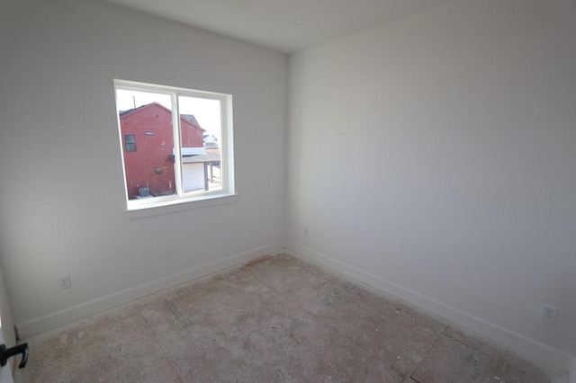 empty room featuring baseboards