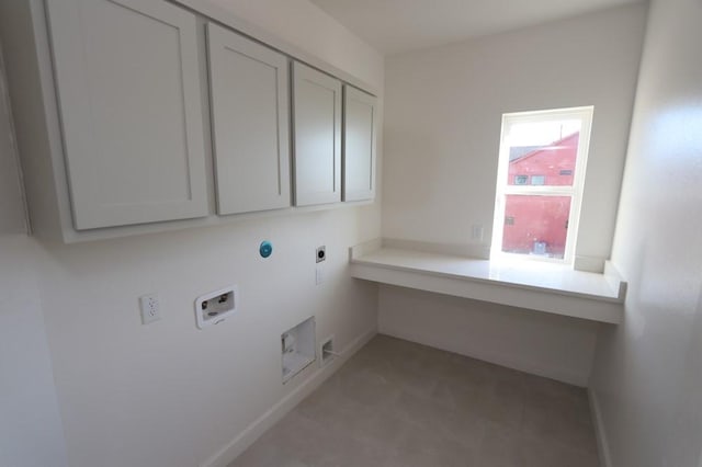 clothes washing area with cabinet space, hookup for a washing machine, electric dryer hookup, and baseboards