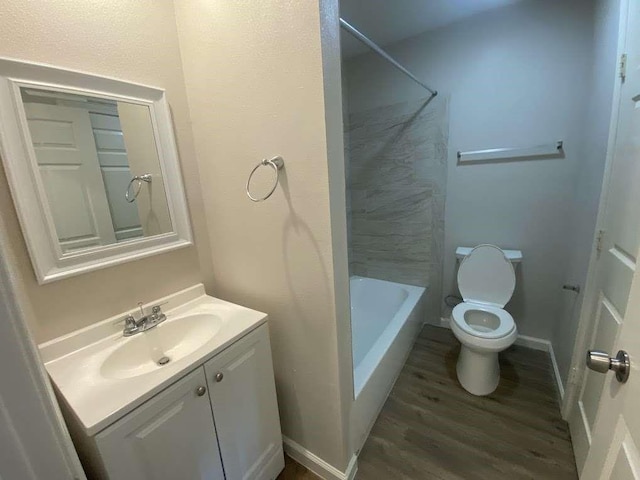 full bathroom featuring vanity, hardwood / wood-style flooring, toilet, and tub / shower combination