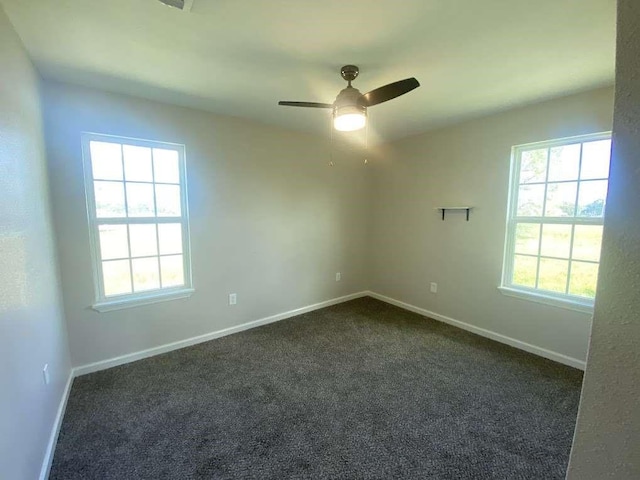 carpeted spare room featuring ceiling fan