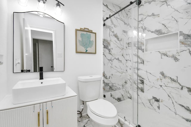 bathroom with vanity, toilet, and a shower with shower door