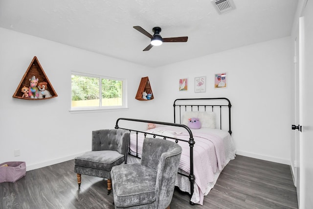 bedroom with ceiling fan and dark wood-type flooring