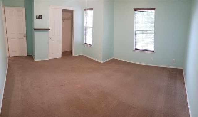 unfurnished bedroom with a closet and carpet floors