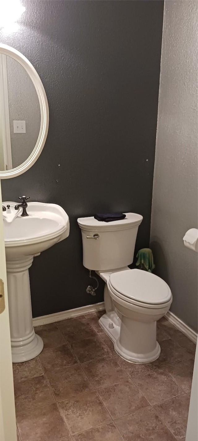 bathroom featuring tile patterned floors, toilet, and sink