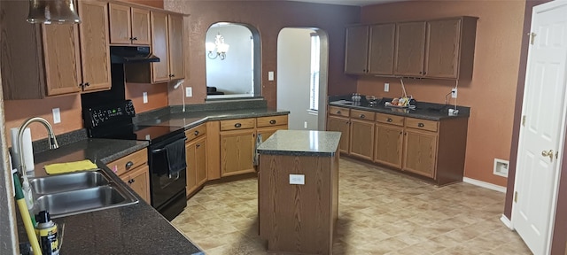 kitchen with a center island, black range with electric stovetop, and sink