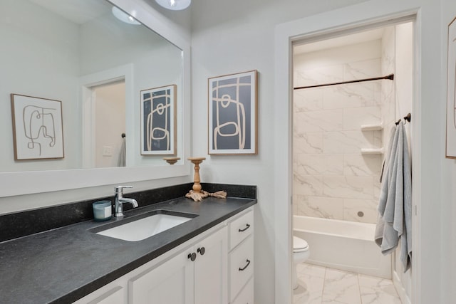 full bathroom featuring vanity, tiled shower / bath combo, and toilet