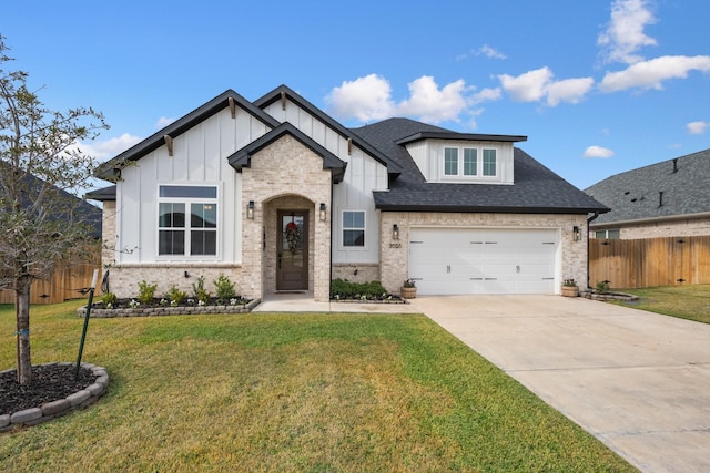 view of front of house with a front yard and a garage