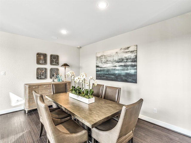 dining area with dark hardwood / wood-style flooring